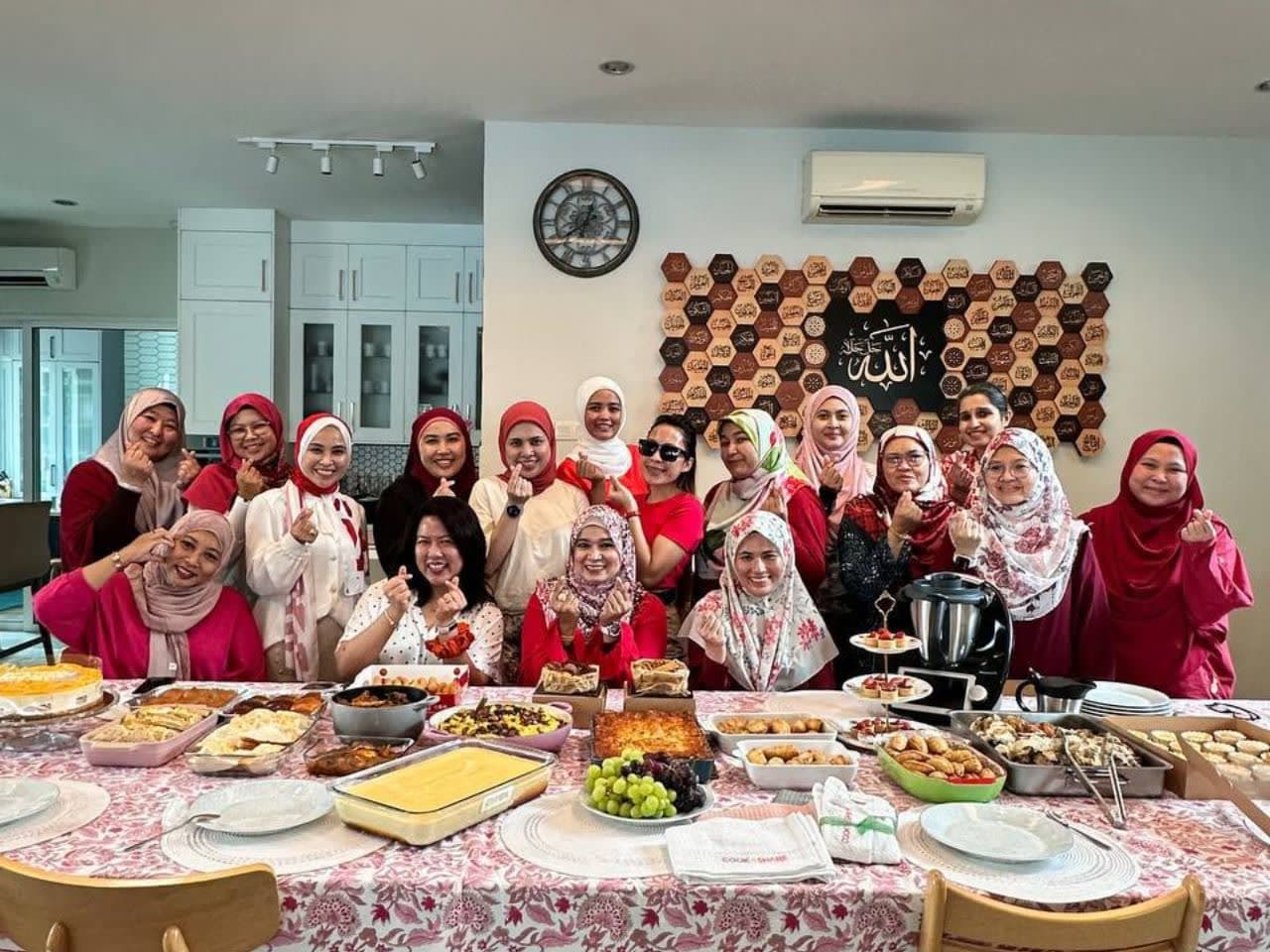 The CooknShare team together behind a festive spread of home-cooked dishes, with a Thermomix®