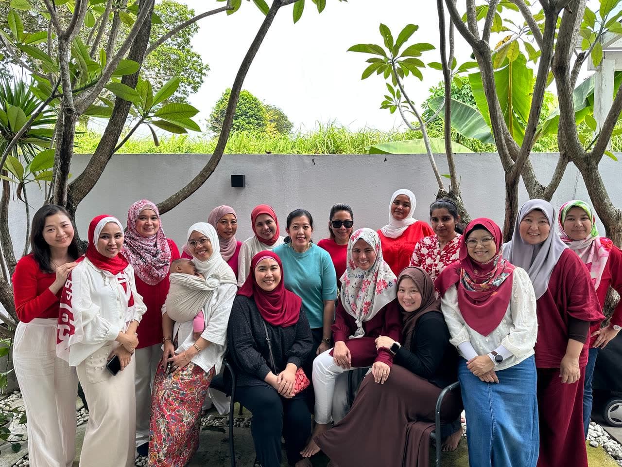 CooknShare members gathered together under frangipani trees in a garden