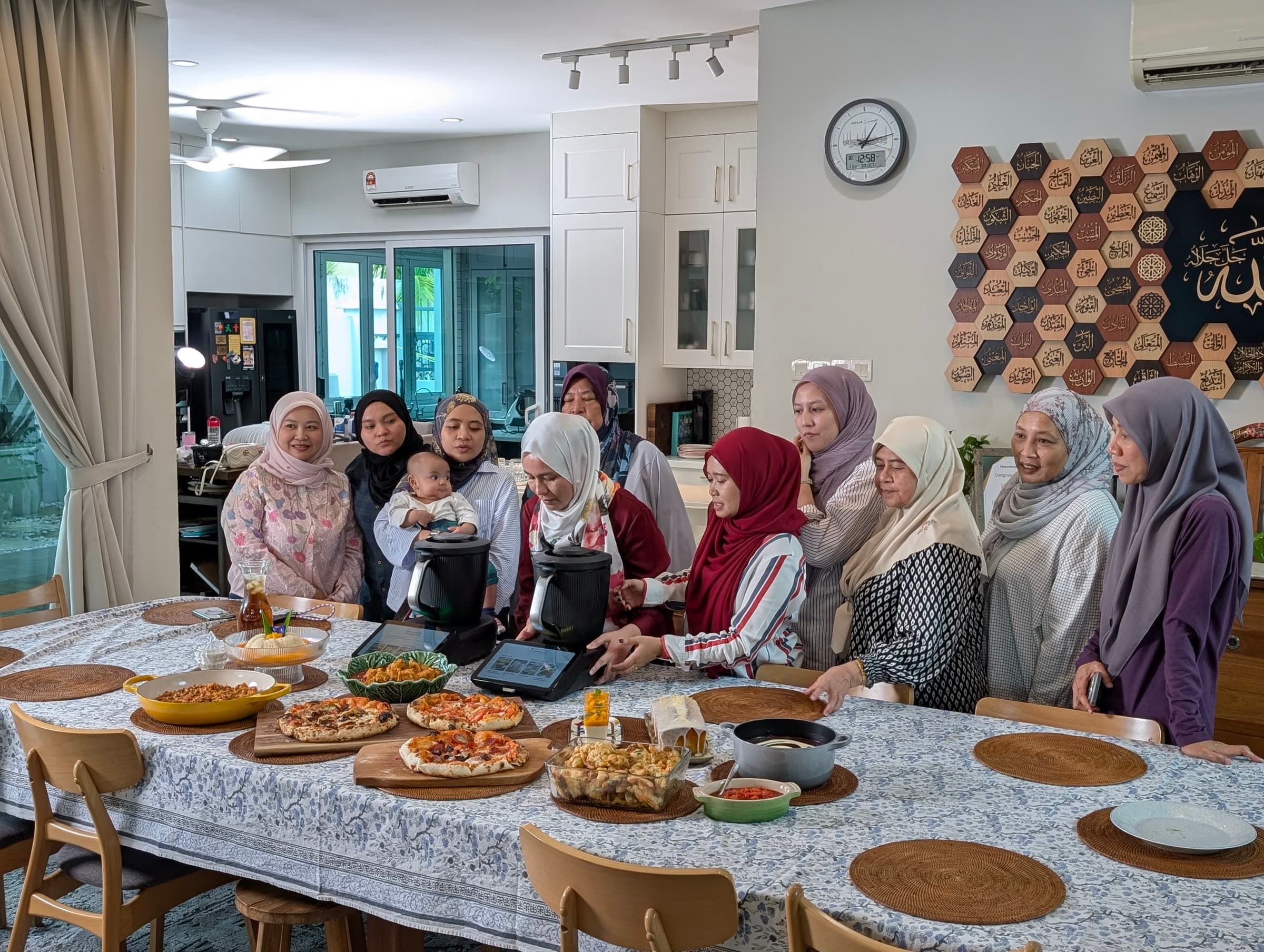 CooknShare members gathered around a table of home-cooked dishes with their Thermomix® machines