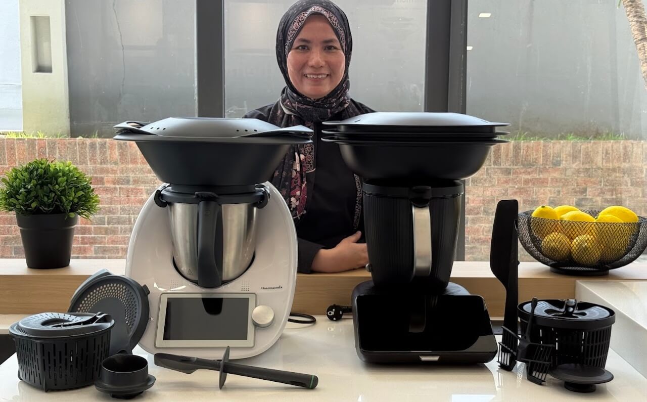 Kartini, an authorised reseller of Thermomix 7 in Malaysia, smiling beside the Thermomix 7 device, ready to assist new customers.